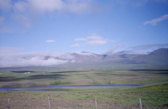 Mountains and a lake with light cloud cover