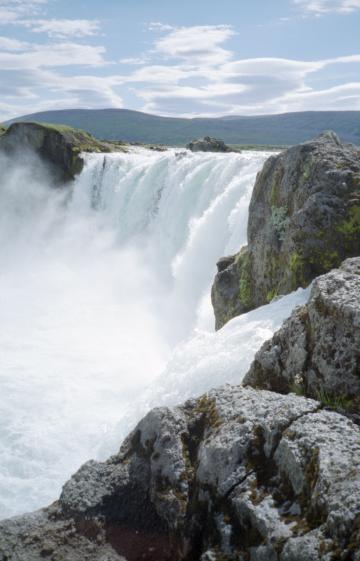 The view across the waterfalls at Goafoss with rocks in the foreground and sky in the background