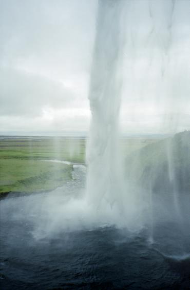 Right behind the jet of the waterfall, looking outward