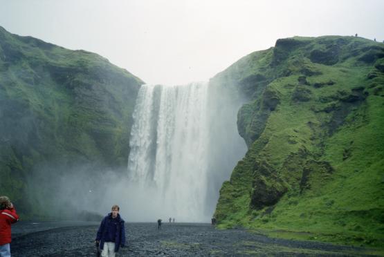 Dave in front of Skgafoss and the green surrounding hillside